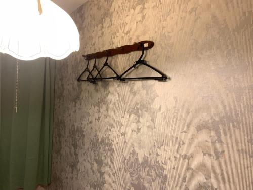 a shelf on a wall with a floral wallpaper at Tokyo Guest House 2020 in Tokyo