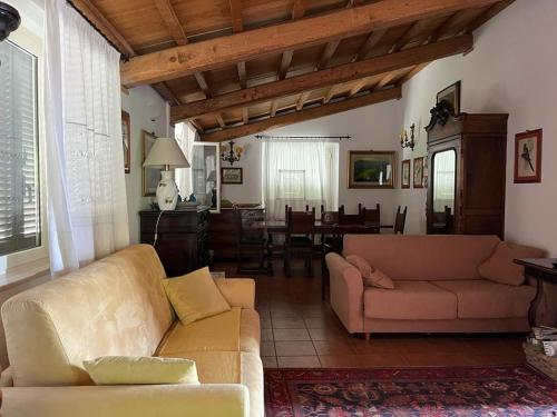 a living room with two couches and a dining room at Agriturismo Il Casaletto in Montefranco
