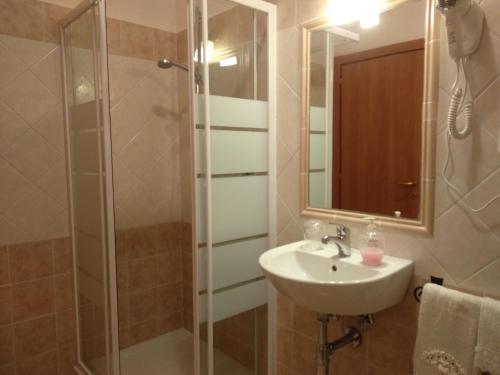 La salle de bains est pourvue d'un lavabo et d'une douche. dans l'établissement Affittacamere Dolce Miele, à Foligno