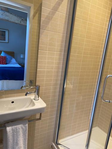 a bathroom with a shower and a sink at Two bed barn in Henley in Arden