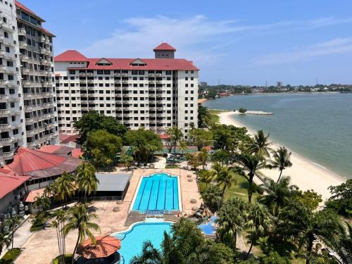 an aerial view of a resort with a swimming pool and a beach at Glory beach private PD in Port Dickson