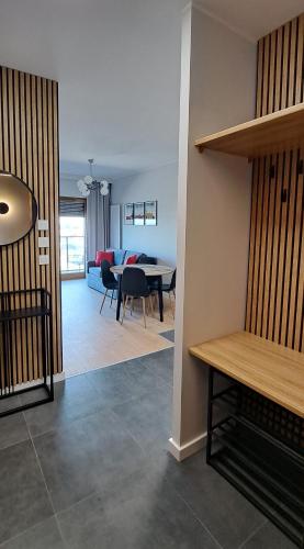 a living room with a table and a dining room at Apartment No 235 in Gdańsk