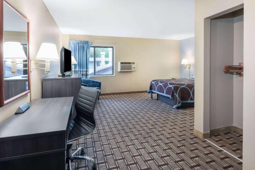 a hotel room with a bed and a desk at Super 8 by Wyndham Marysville/Port Huron Area in Marysville