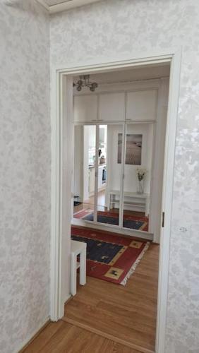 a view of a room with a mirror and a hallway at Lovely apartment in Itäsatama in Hanko