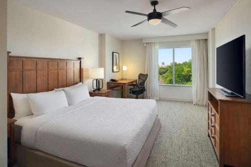 a bedroom with a bed and a flat screen tv at Homewood Suites Atlanta Midtown in Atlanta