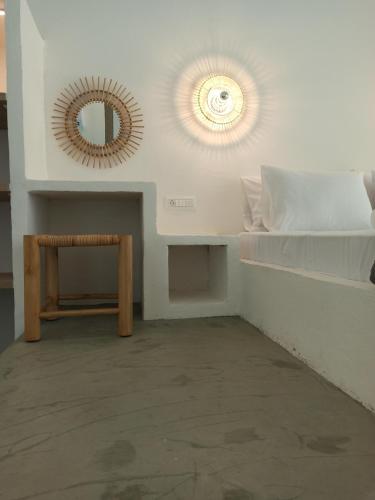 a room with a bed and a mirror on the wall at Nomadic Ambience in Parga