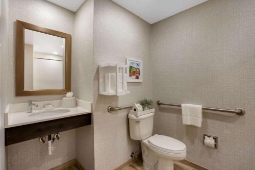 a bathroom with a toilet and a sink and a mirror at Hampton Inn Philadelphia/Willow Grove in Willow Grove