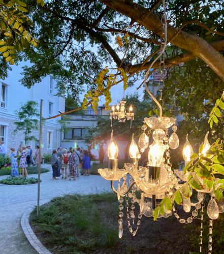 a chandelier hanging from a tree in a park at Kurkowa Apartments in Szczecin