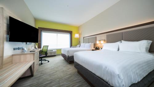a hotel room with two beds and a flat screen tv at Holiday Inn Express & Suites - Southaven Central - Memphis by IHG in Southaven