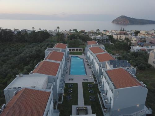 an aerial view of a building with a swimming pool at Sunrise Village Hotel - All Inclusive in Plataniás