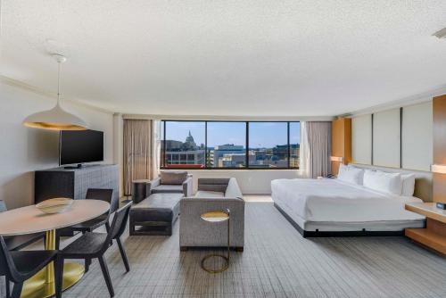 a hotel room with a bed and a living room at Hilton Washington DC Capitol Hill in Washington, D.C.