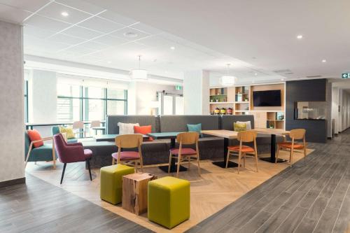 a waiting room with a table and chairs at Home2 Suites By Hilton Quebec City in Quebec City