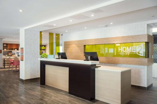 a lobby with a home office with two computers at Home2 Suites By Hilton Quebec City in Quebec City