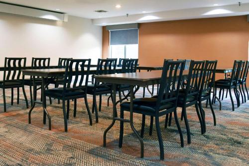 a conference room with wooden tables and chairs at Comfort Inn & Suites NW Milwaukee in Germantown