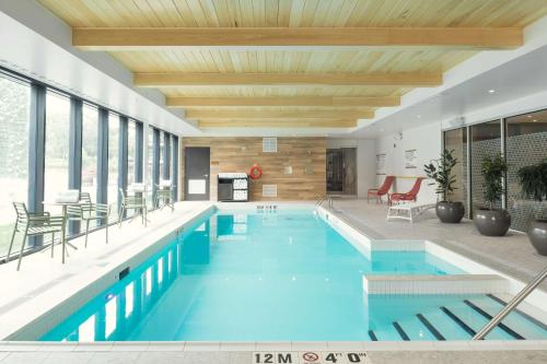 a large swimming pool with a wooden ceiling at Home2 Suites By Hilton Quebec City in Quebec City
