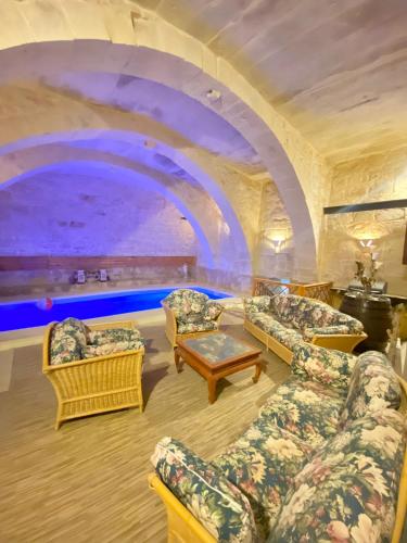 a living room with couches and a large aquarium at Vintage Farmhouse in Qormi