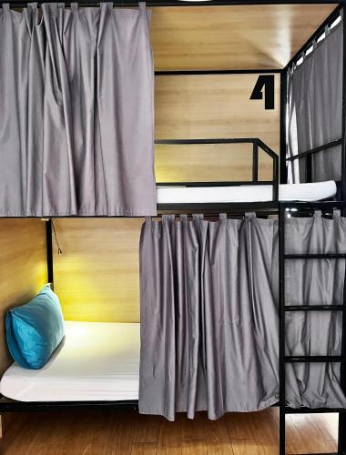 a couple of bunk beds in a room at THE PLACE Hostel Siem Reap Angkor in Siem Reap