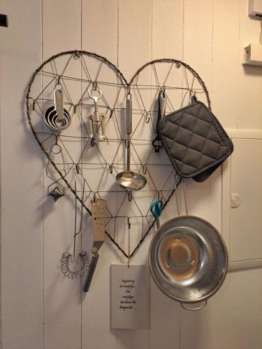 a heart shaped rack with various items on a wall at Harmony in Farhult in Farhult