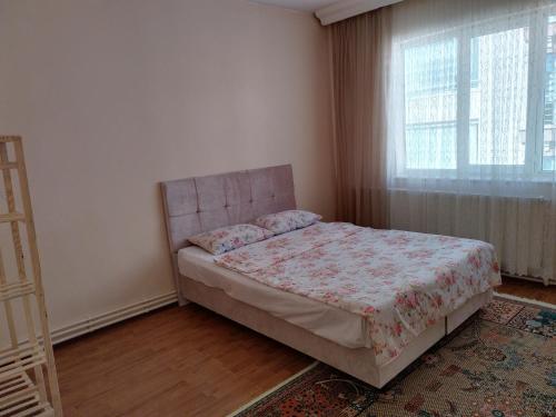 a bedroom with a bed and a window at hilal in Erzurum