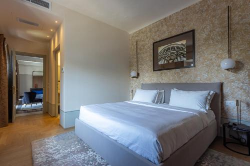a bedroom with a large white bed in a room at Grand Universe La Residenza in Lucca
