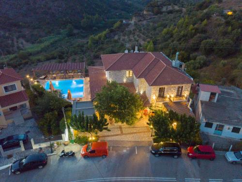 a large house with cars parked in a parking lot at Bacchus Villa in Archea Pissa