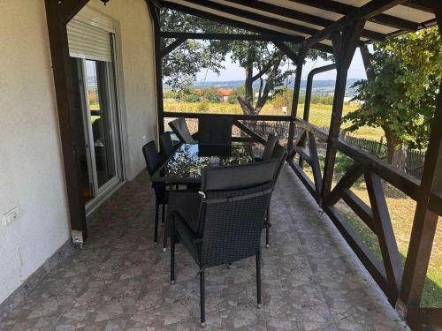 a patio with a table and chairs on a balcony at Vila Sava in Sopot