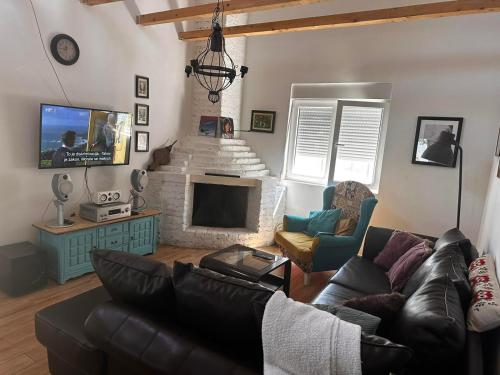 a living room with a couch and a fireplace at Vila Sava in Sopot