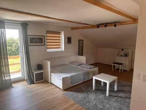 a bedroom with a bed and a table in it at Vila Sava in Sopot