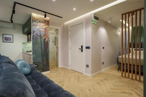 a living room with a couch and a sliding door at IDEA LUX Apartmani Kragujevac in Kragujevac