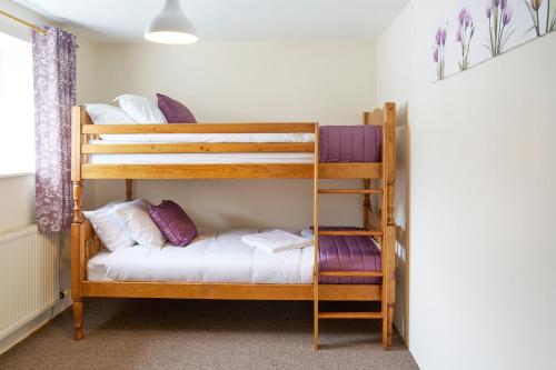 a room with two bunk beds and a ladder at The Barn (Chilsworthy), 6 Sleeper House, 19 Min Drive into Bude, Cornwall in Holsworthy