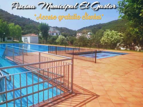 a swimming pool with a metal fence around it at Castor y Polux in El Gastor