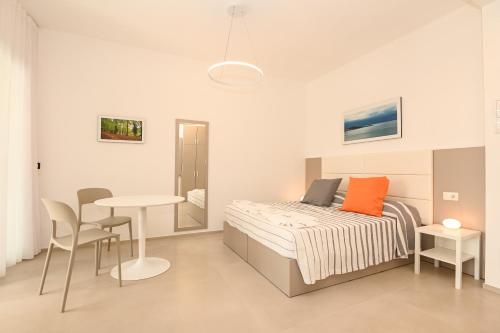 Кровать или кровати в номере Agorà Vieste Rooms & Apartments