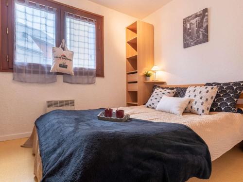 - une chambre avec un lit, un canapé et des fenêtres dans l'établissement Charmant T2 proche commerces et téléphérique avec navette gratuite et casier à skis - FR-1-296-368, à Saint-Lary-Soulan