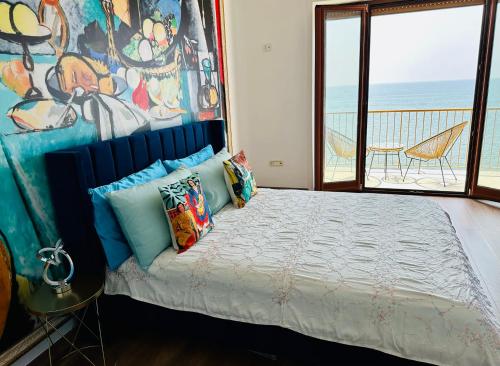 a bedroom with a bed with a view of the ocean at BluMare ArtHouse in Salerno