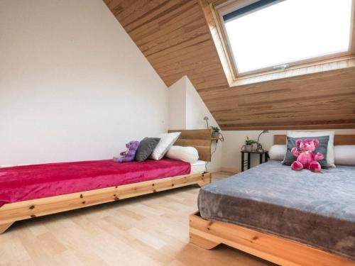 a bedroom with two beds and a skylight at Appartement cosy 6 personnes avec parking à Saint-Lary - FR-1-296-382 in Saint-Lary-Soulan