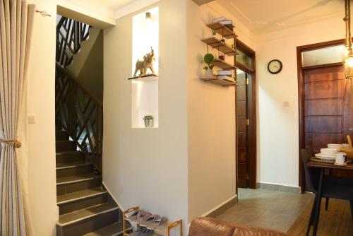 a hallway with a stairway leading to a house at Gamaleo Apartment Namulanda in Namulanda