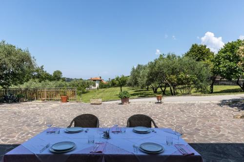 a table with a blue table cloth on a patio at Affittacamere Cigui in Muggia