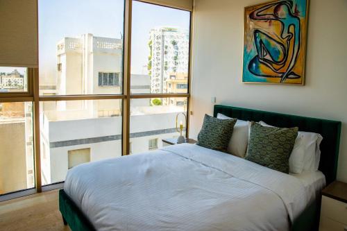 a bedroom with a large bed and a large window at Phaedrus Living: 360 Tower Luxury Flat in Nicosia