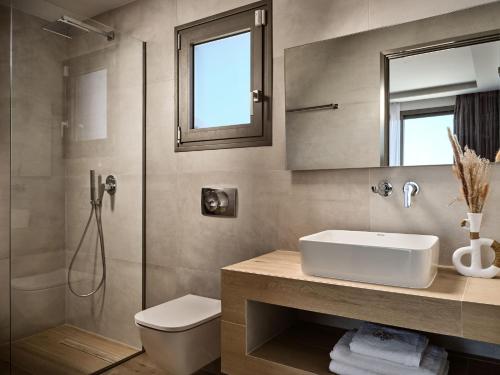 a bathroom with a toilet and a sink and a shower at Kapodistria Luxury Villas - Serene Escape in a Scenic, Secluded Location, by ZanteWize in Plános