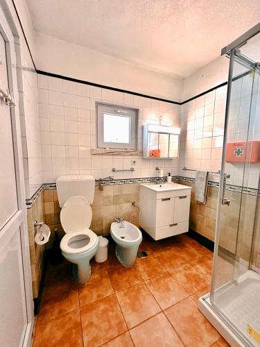 a bathroom with a toilet and a sink at Casa Girassol with a beautiful private Pool and Garden in Sintra