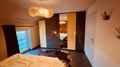 a bedroom with a bed and a large mirror at BeCosy Triplex chic et moderne style Loft in Beloeil