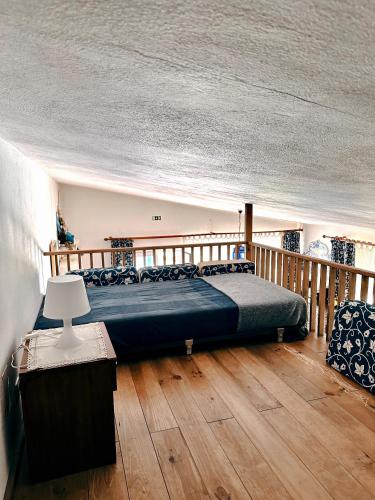 a bedroom with a bed and a wooden floor at Casa Girassol with a beautiful private Pool and Garden in Sintra