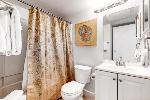 a bathroom with a toilet and a sink at Villa Del Sol Villa Views in Corpus Christi