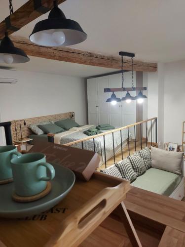 a room with two bunk beds and a table with a coffee cup at Studio al Mulino in Rovinj