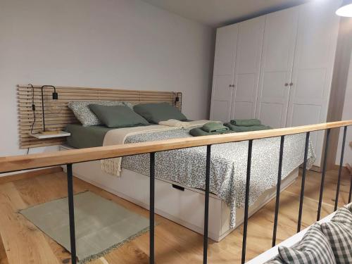 a small bedroom with a bed and a railing at Studio al Mulino in Rovinj