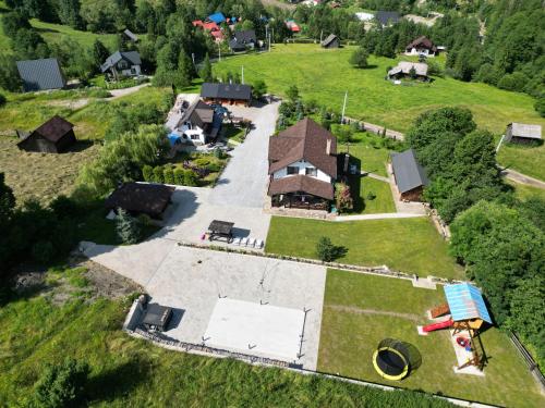 an aerial view of a house in a field at Casa Izvorul Rarăului in Câmpulung Moldovenesc