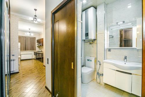 a bathroom with a toilet and a sink at Apartment Lux in Baku