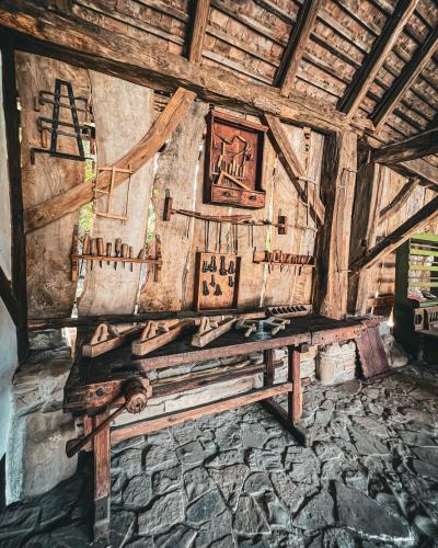 a room with a wooden table in a building at Castle View Saschiz - Traditional Guesthouse in Saschiz
