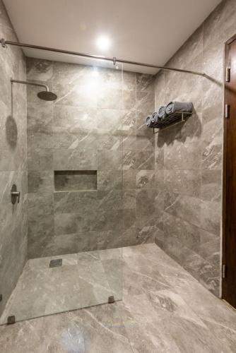 a bathroom with a shower with a glass door at Hotel One in Cebu City
