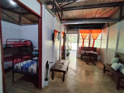 a room with a room with bunk beds and a table at Maricel House in San Rafael